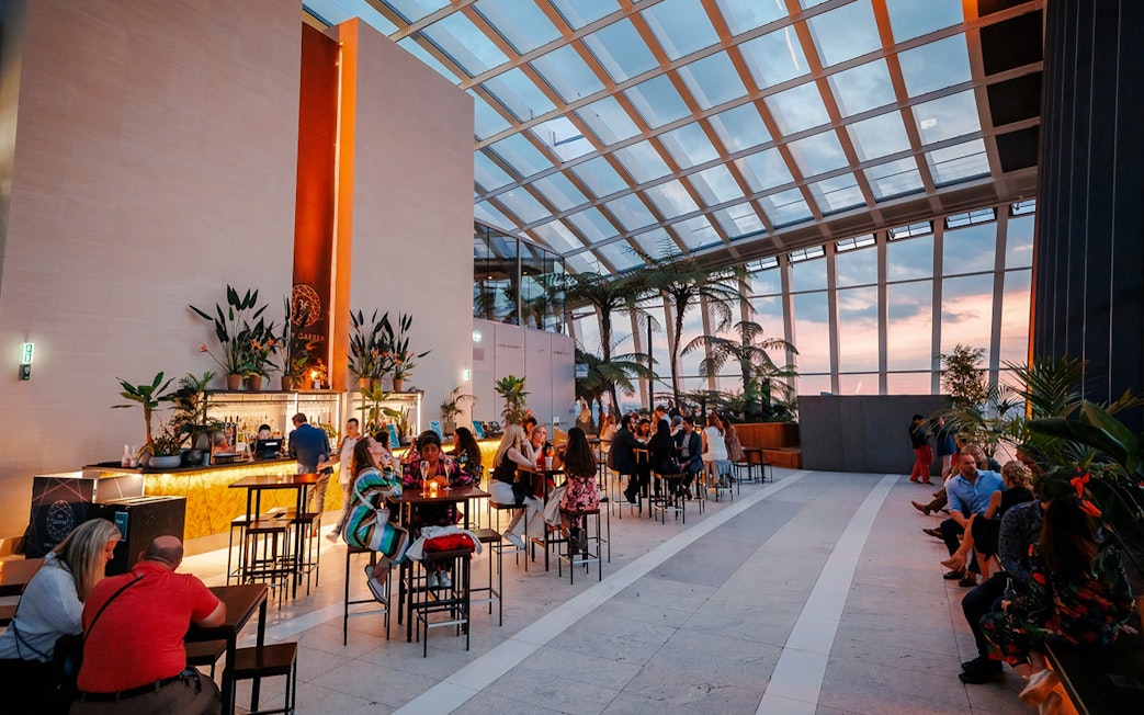 Guests enjoying Music Night at Sky Garden with sunset views.