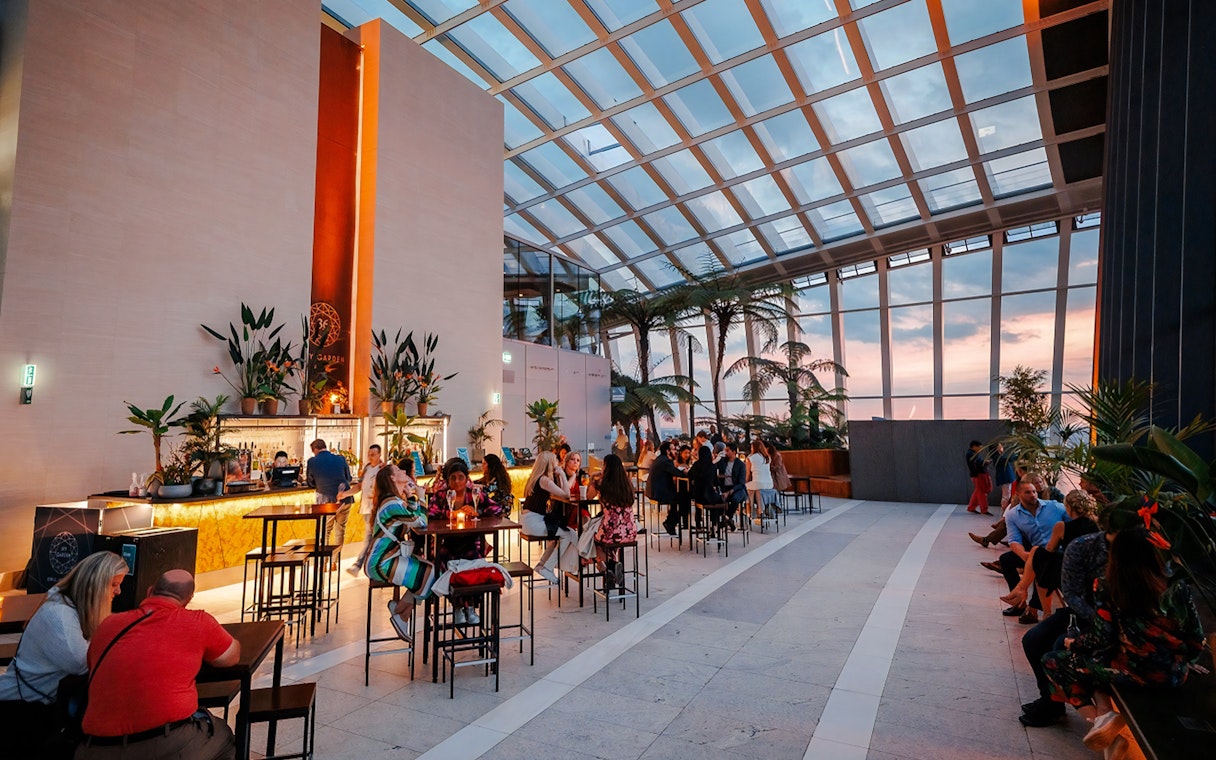 Guests enjoying Music Night at Sky Garden with sunset views.