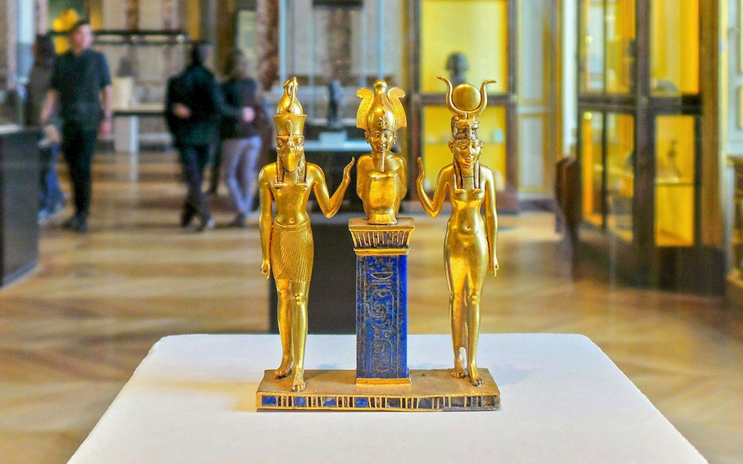 Golden Egyptian statues on display at the National Museum of Egyptian Civilization in Cairo.