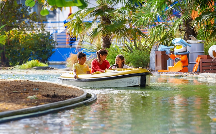 Family enjoying a boat ride at LEGOLAND Windsor Resort.