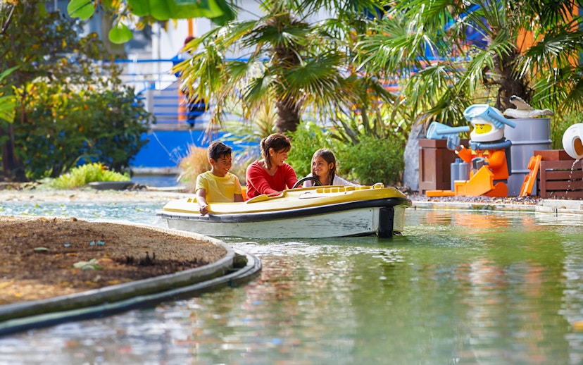 Family enjoying a boat ride at LEGOLAND Windsor Resort.
