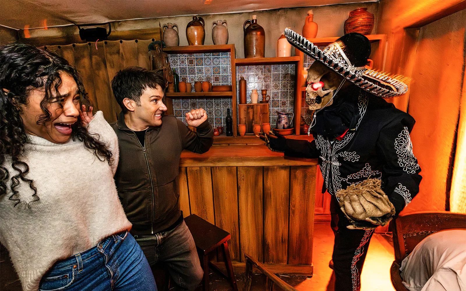Guests reacting to a costumed performer at Hollywood Horror Nights, Universal Studios Hollywood, Los Angeles.