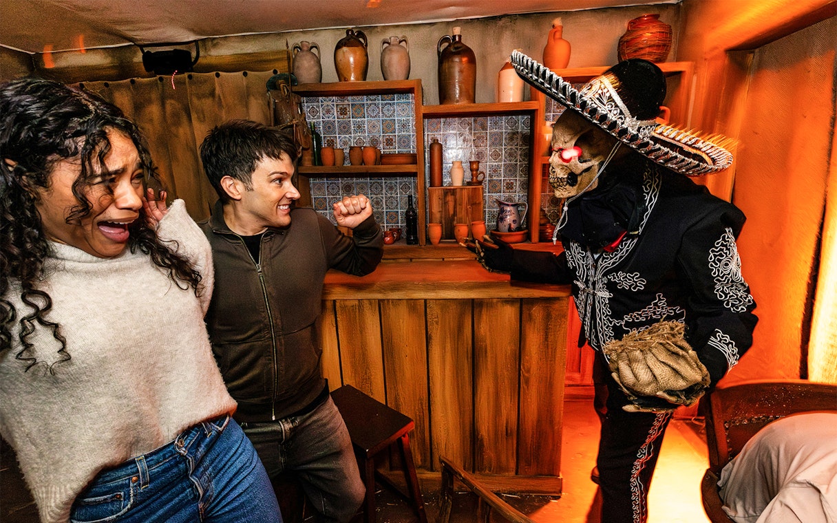 Guests reacting to a costumed performer at Hollywood Horror Nights, Universal Studios Hollywood, Los Angeles.