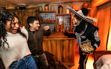 Guests reacting to a costumed performer at Hollywood Horror Nights, Universal Studios Hollywood, Los Angeles.