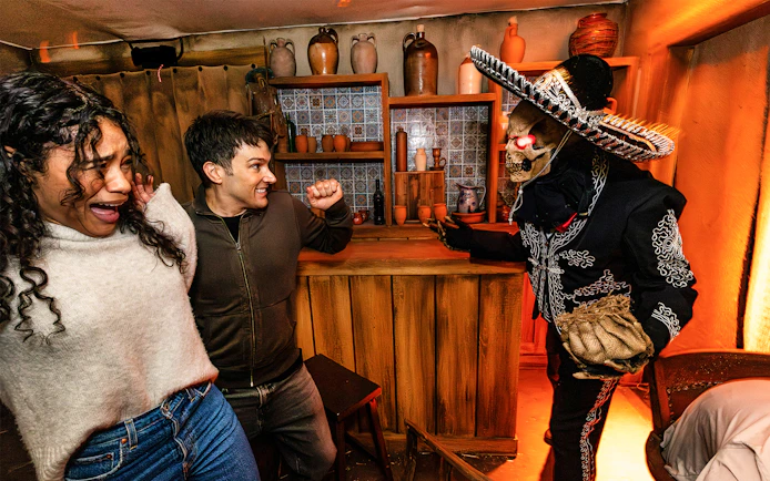 Guests reacting to a costumed performer at Hollywood Horror Nights, Universal Studios Hollywood, Los Angeles.