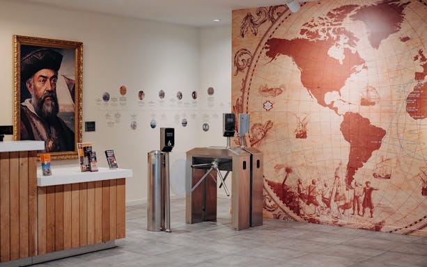 World of Discoveries entrance with explorer portrait and vintage world map.