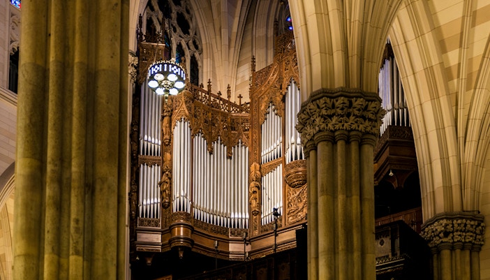 Pipe organ at St. Patrick's Cathedral, New York, framed by ornate columns.