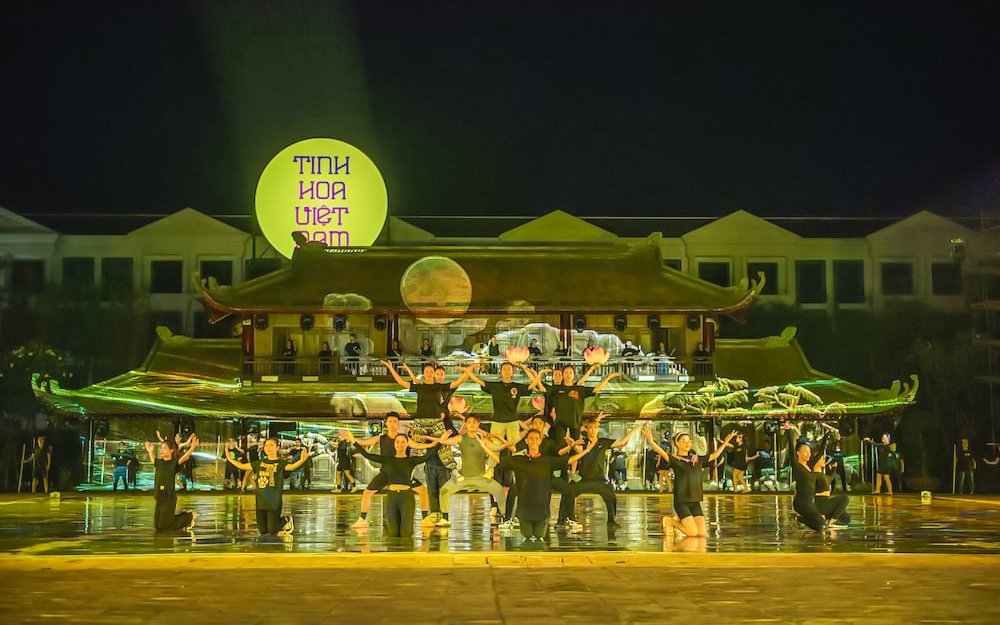 Performers on stage at The Quintessence of Vietnam Show, Hanoi, with traditional backdrop.