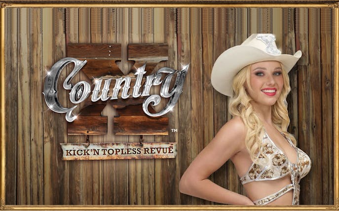 Country X Kick'n Topless Revue sign with performer in cowboy hat, Vegas.