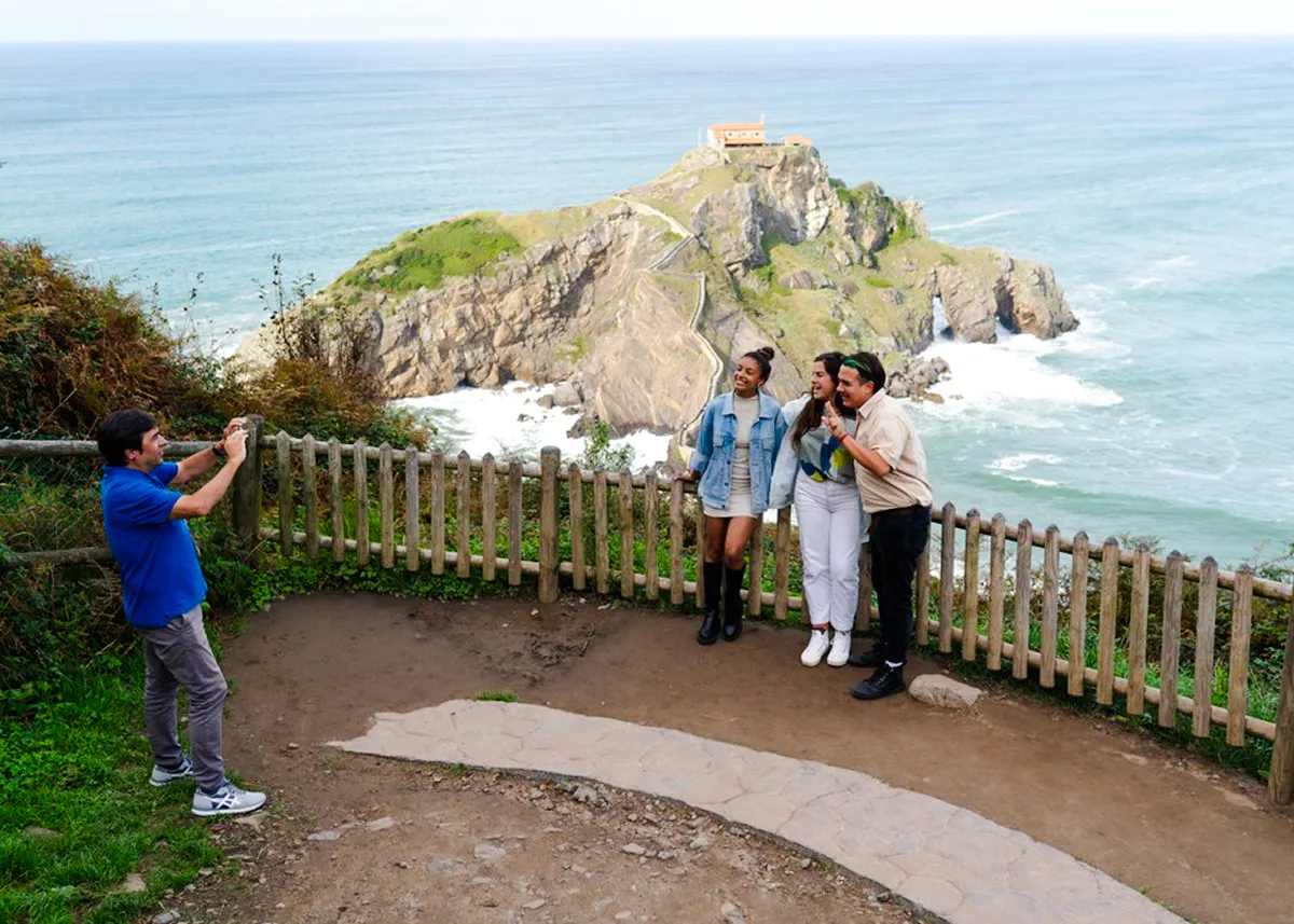 Visitors posing at San Juan de Gaztelugatxe, Dragonstone filming location, near San Sebastian.