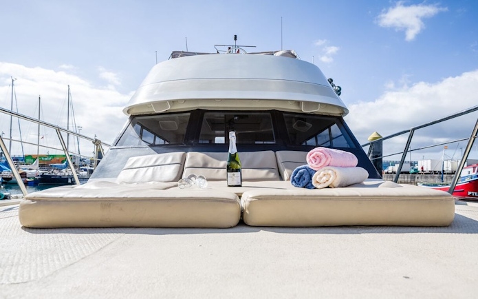 Shared yacht deck with champagne and towels, Tenerife Whale and Dolphin Watching tour.