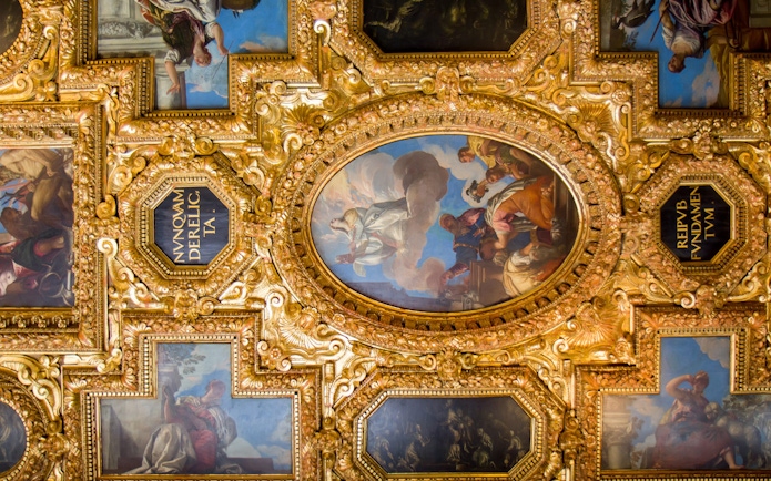Doge Palace ceiling with "Triumph of Venice" painting, ornate gold frames, Venice, Italy.