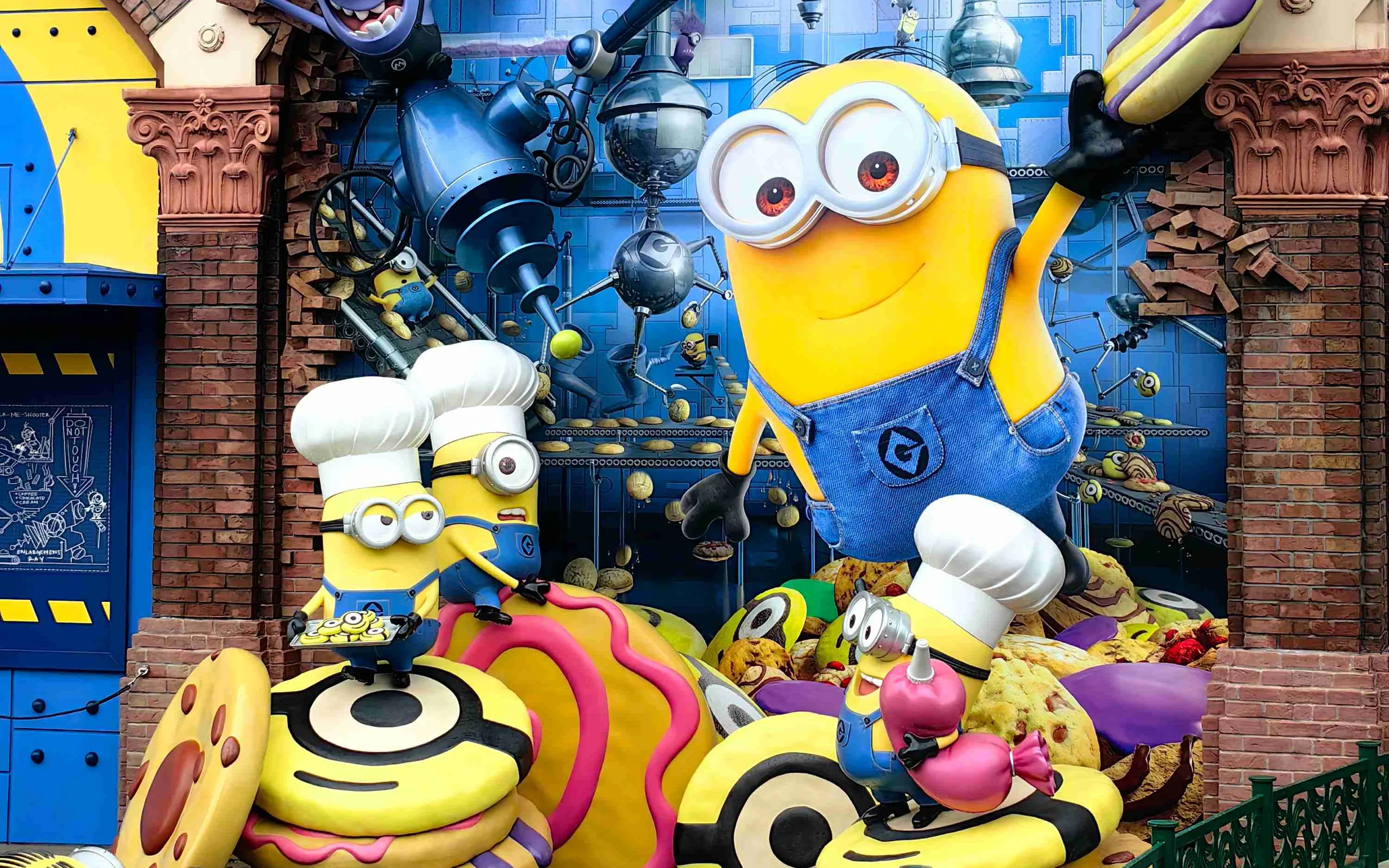 Minion Park statue with Minions in chef hats holding desserts at Universal Studios Japan.