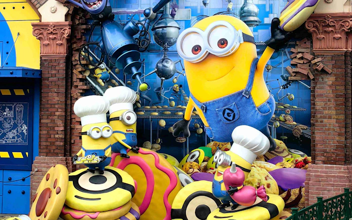 Minion Park statue with Minions in chef hats holding desserts at Universal Studios Japan.