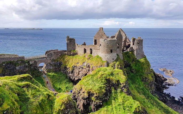 Dunluce Castle ruins on a cliff overlooking the sea in Northern Ireland.