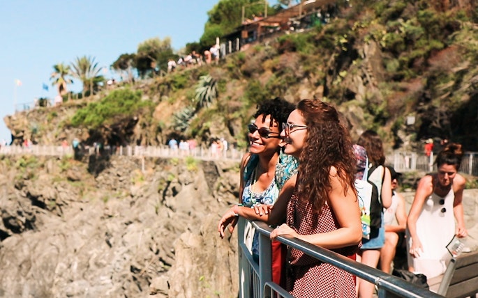 Visitors enjoying the scenic view of Cinque Terre cliffs on a guided tour from Florence.