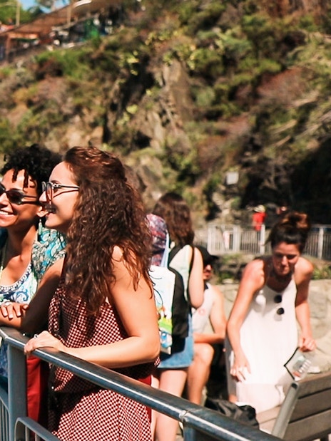 Visitors enjoying the scenic view of Cinque Terre cliffs on a guided tour from Florence.