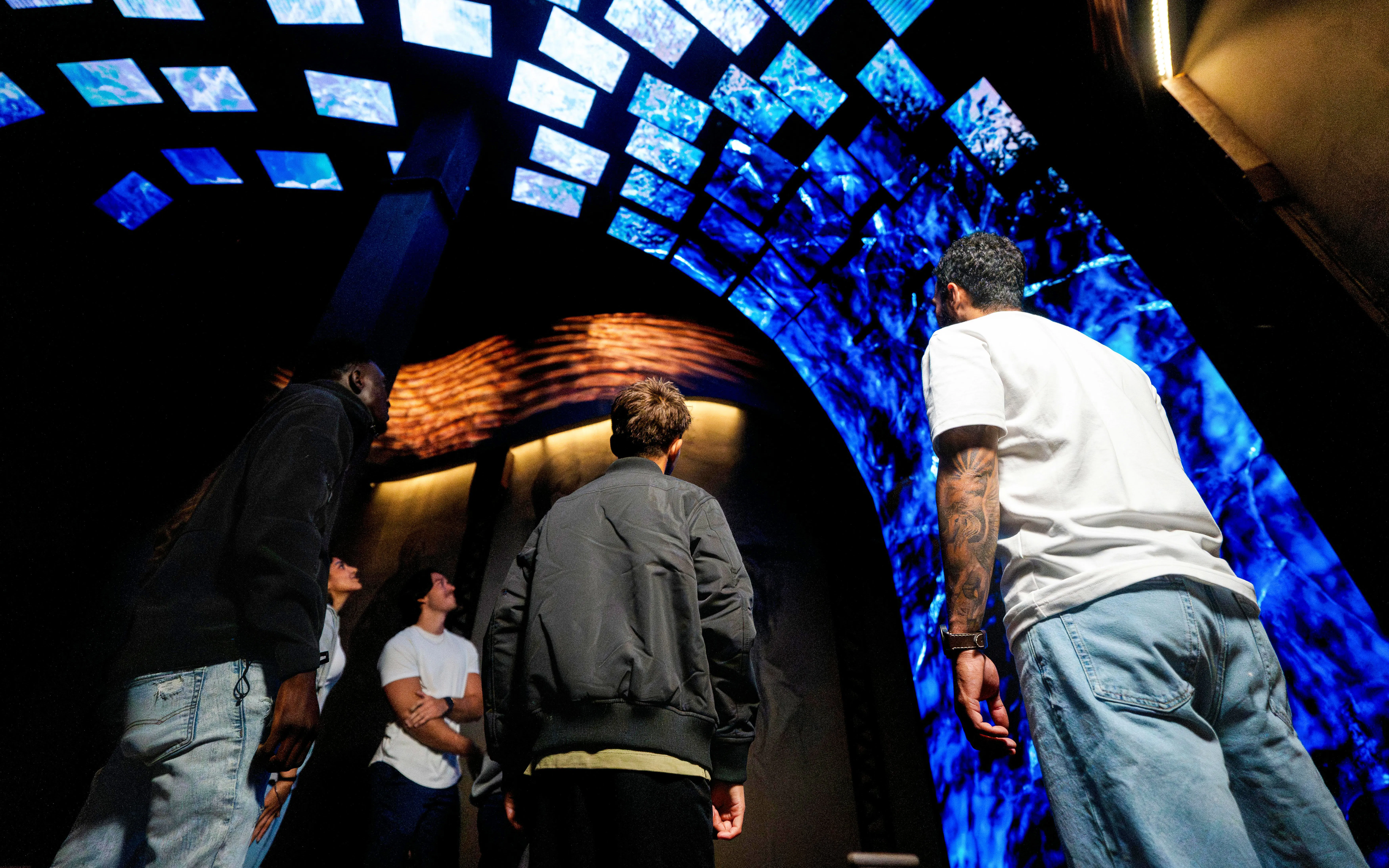Visitors observing immersive digital display at Niagara Takes Flight, Canada.