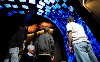 Visitors observing immersive digital display at Niagara Takes Flight, Canada.