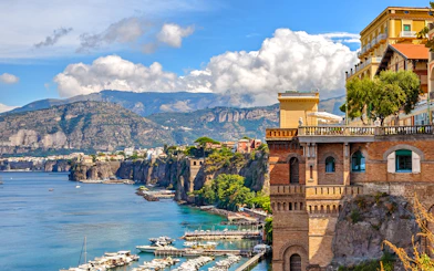 Sorrento coast with cliffs, marina, and historic buildings.