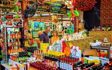 Kuranda Heritage Markets stall with hot sauces and local products, part of Scenic Train and Skyrail Kuranda Tour.