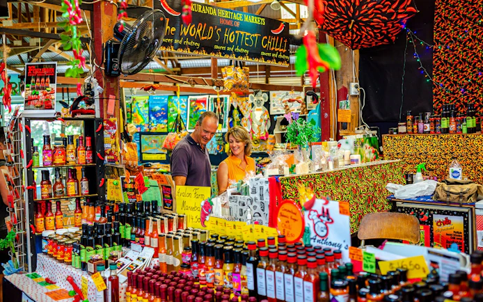 Kuranda Heritage Markets stall with hot sauces and local products, part of Scenic Train and Skyrail Kuranda Tour.