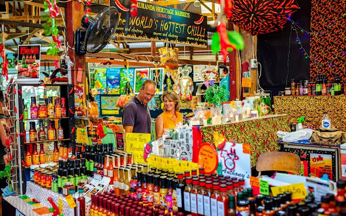 Kuranda Heritage Markets stall with hot sauces and local products, part of Scenic Train and Skyrail Kuranda Tour.