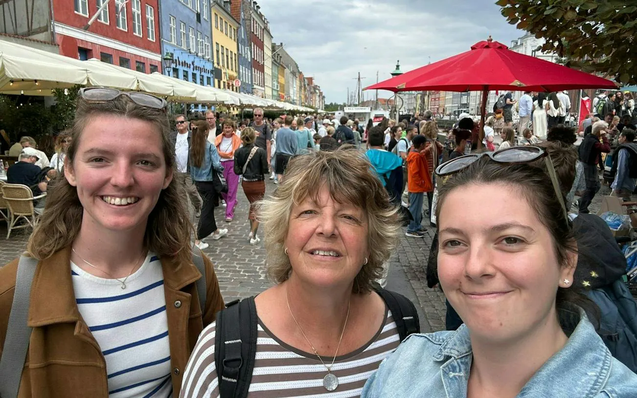 Crowd exploring Nyhavn, Copenhagen during a self-guided murder mystery game.