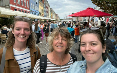 Crowd exploring Nyhavn, Copenhagen during a self-guided murder mystery game.