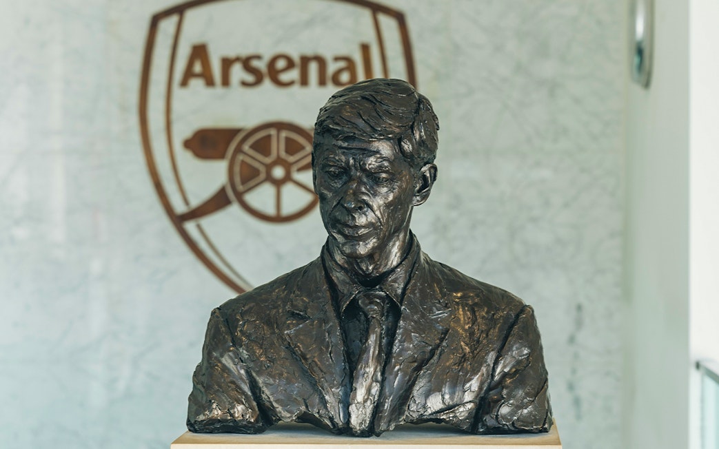 Bust of a man in front of Arsenal logo at the Arsenal Museum, Emirates Stadium, London.