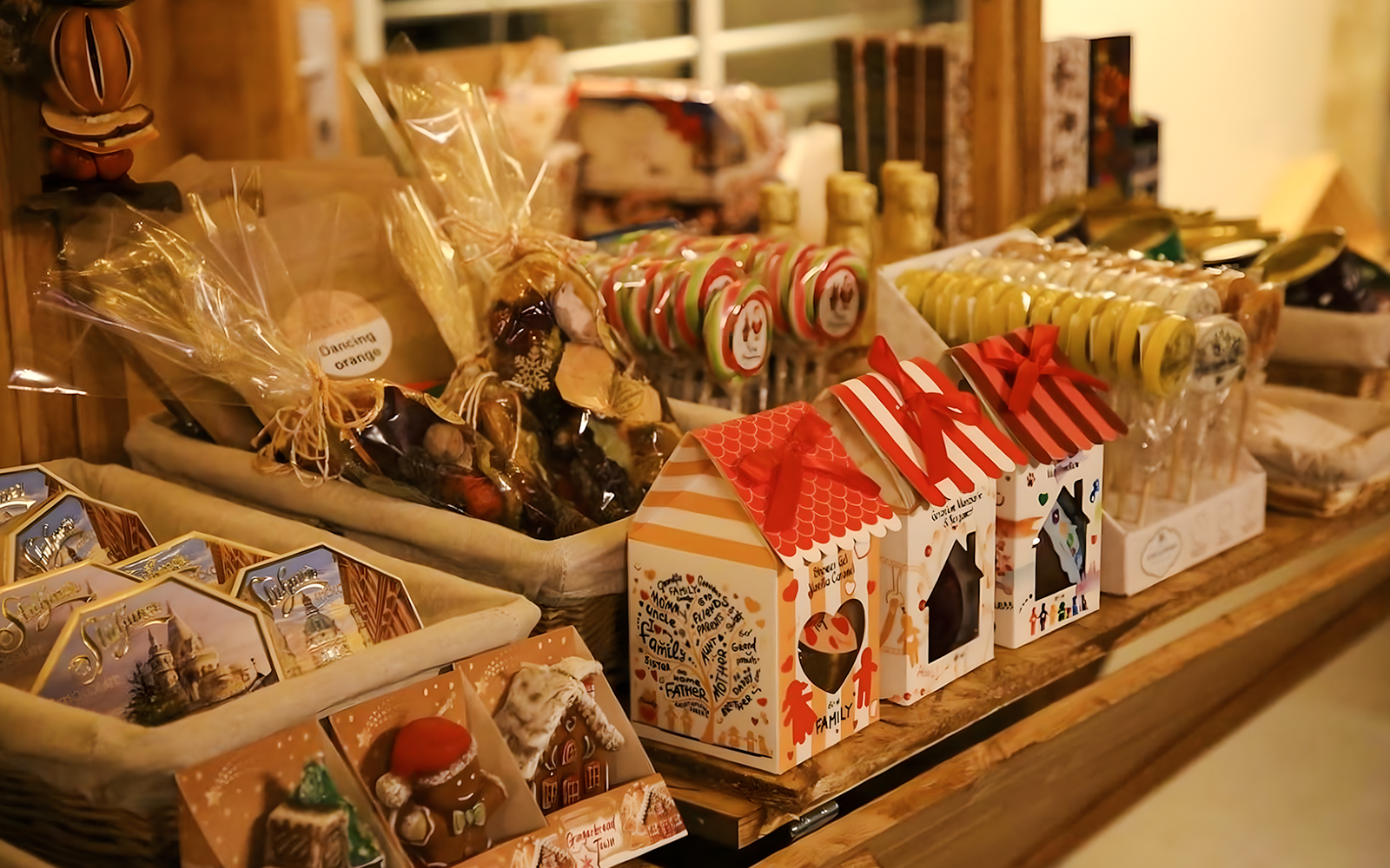 Christmas market stall with festive treats and gift boxes in Budapest.