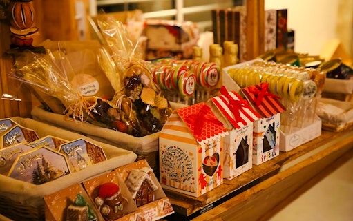 Christmas market stall with festive treats and gift boxes in Budapest.