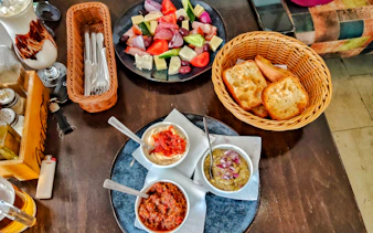 Traditional Romanian appetizers with bread, dips, and salad on the Taste of Bucharest tour.