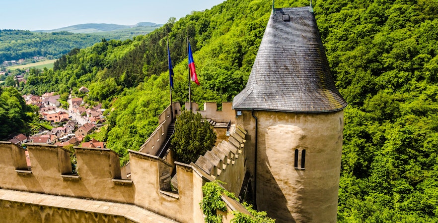 Well tower at Karlstejn Castle surrounded by lush greenery, Czech Republic.