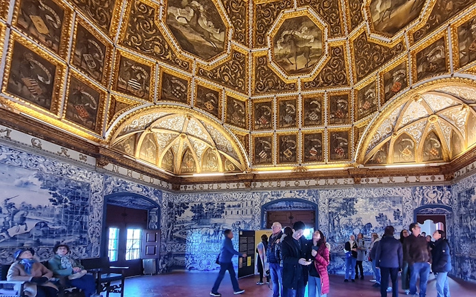 Sintra National Palace interior with ornate ceiling and blue azulejos tiles.