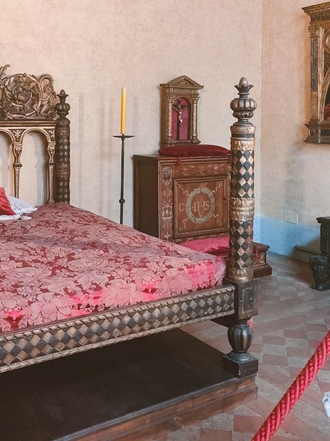 Ornate bedroom with carved bed in Castel Sant'Angelo, Rome.