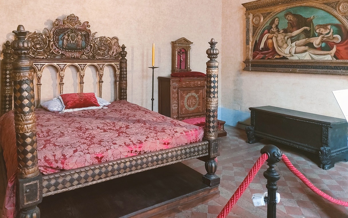 Ornate bedroom with carved bed in Castel Sant'Angelo, Rome.