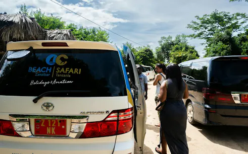 Tourists gather near a safari van in Zanzibar for the Stone Town walking tour and upcycling workshop.