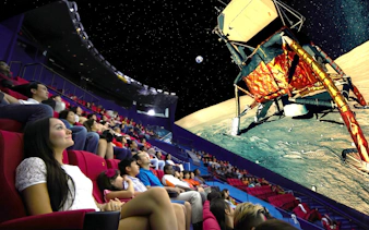 Audience watching a space-themed show at Science Centre Singapore planetarium.