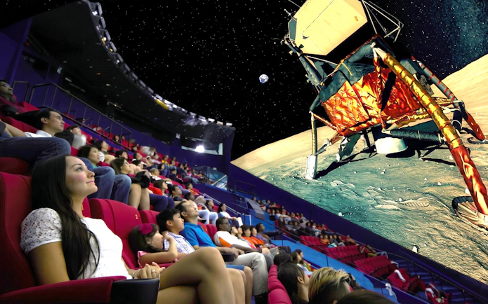 Audience watching a space-themed show at Science Centre Singapore planetarium.