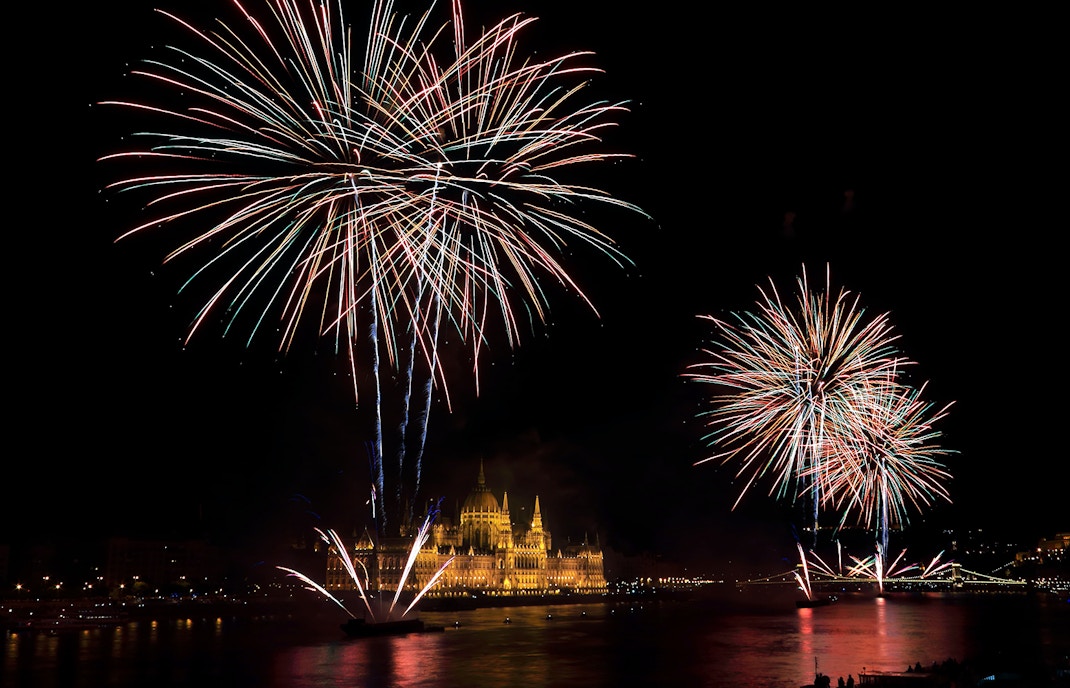 Fireworks illuminating the sky above the Hungarian Parliament in Budapest.