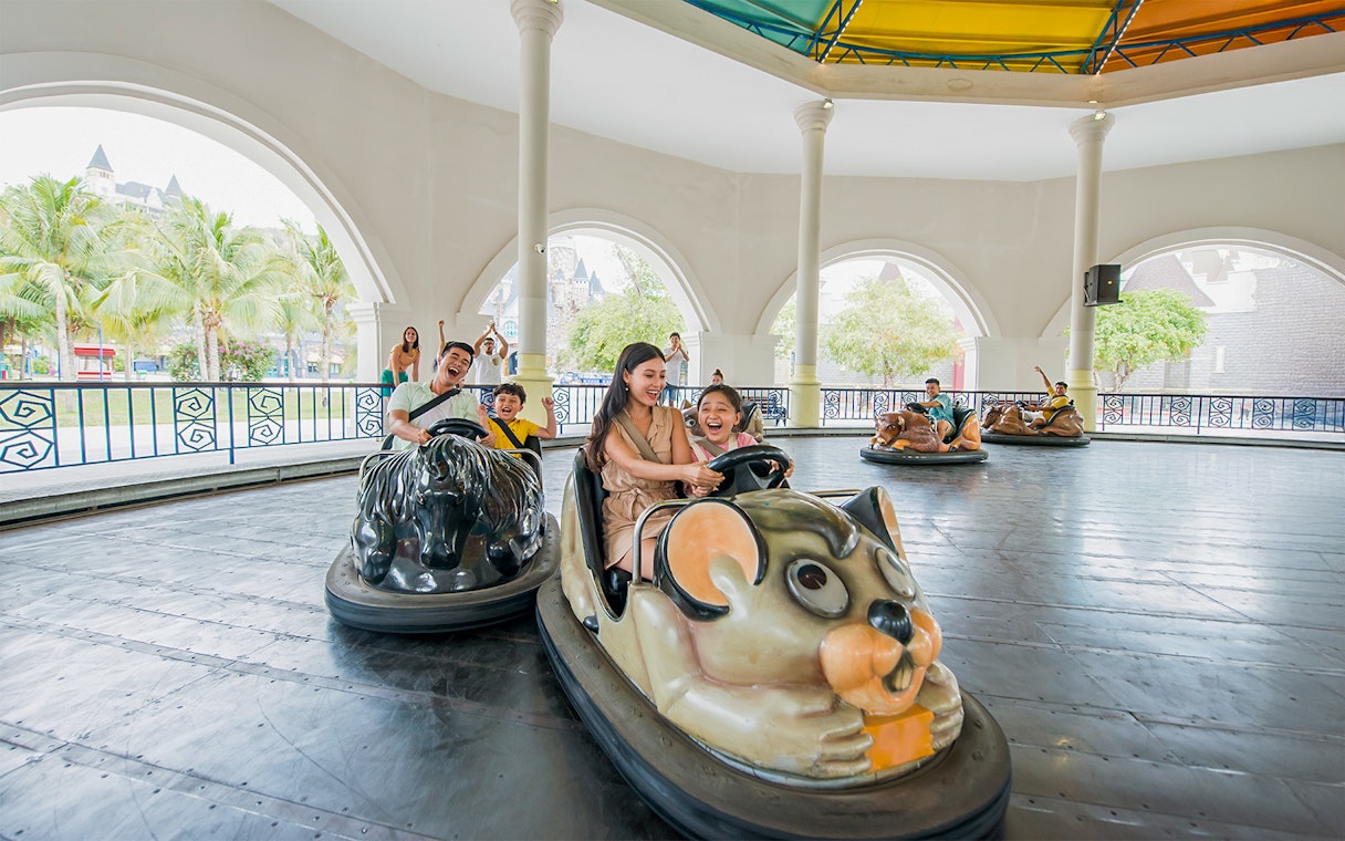 Family enjoying bumper cars at VinWonders Nha Trang Theme Park.