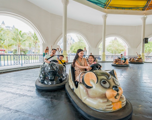 Family enjoying bumper cars at VinWonders Nha Trang Theme Park.