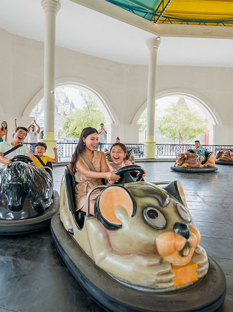 Family enjoying bumper cars at VinWonders Nha Trang Theme Park.