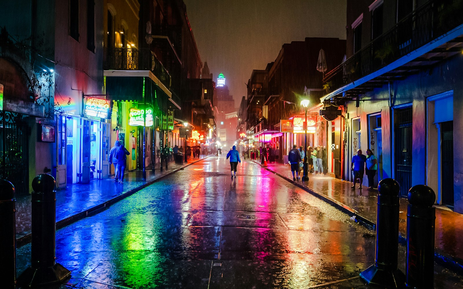 Bourbon Street, New Orleans with vibrant street scene in the background.