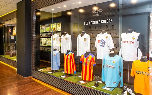 Valencia CF jerseys displayed at Mestalla Forevertour exhibit in Valencia.