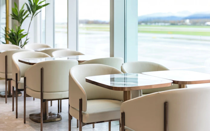 Seating area in Plaza Premium Lounge, Vancouver International Airport, with runway view.