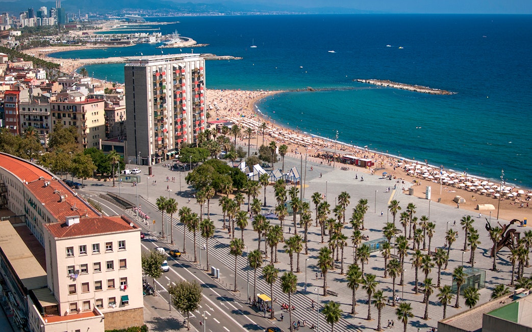 Barcelona beach view near Montjuic, showcasing cityscape and coastline.