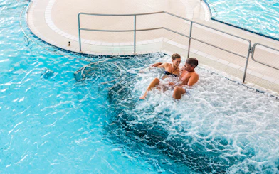 Couple relaxing in a jacuzzi at Chocholow Thermal Baths, Poland.