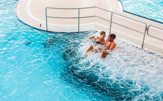Couple relaxing in a jacuzzi at Chocholow Thermal Baths, Poland.